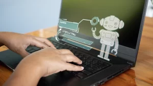 Person working on a laptop with an AI bot assisting them.