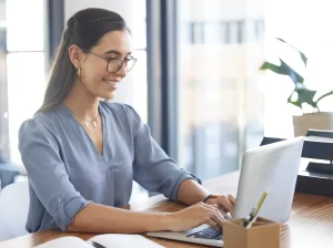 business woman on laptop typing a report or copywriting in an office