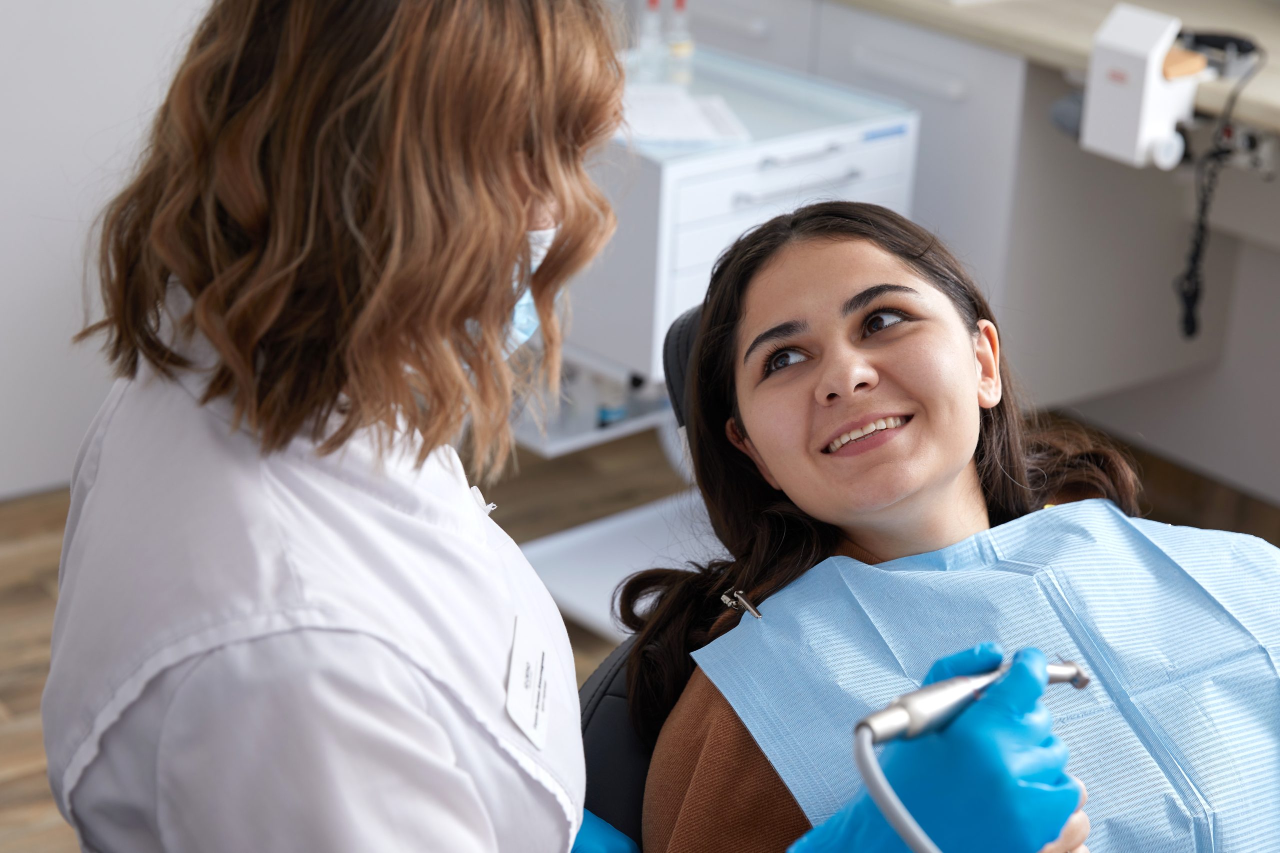 A Dentist SEO client performs a scale and polish on a happy patient