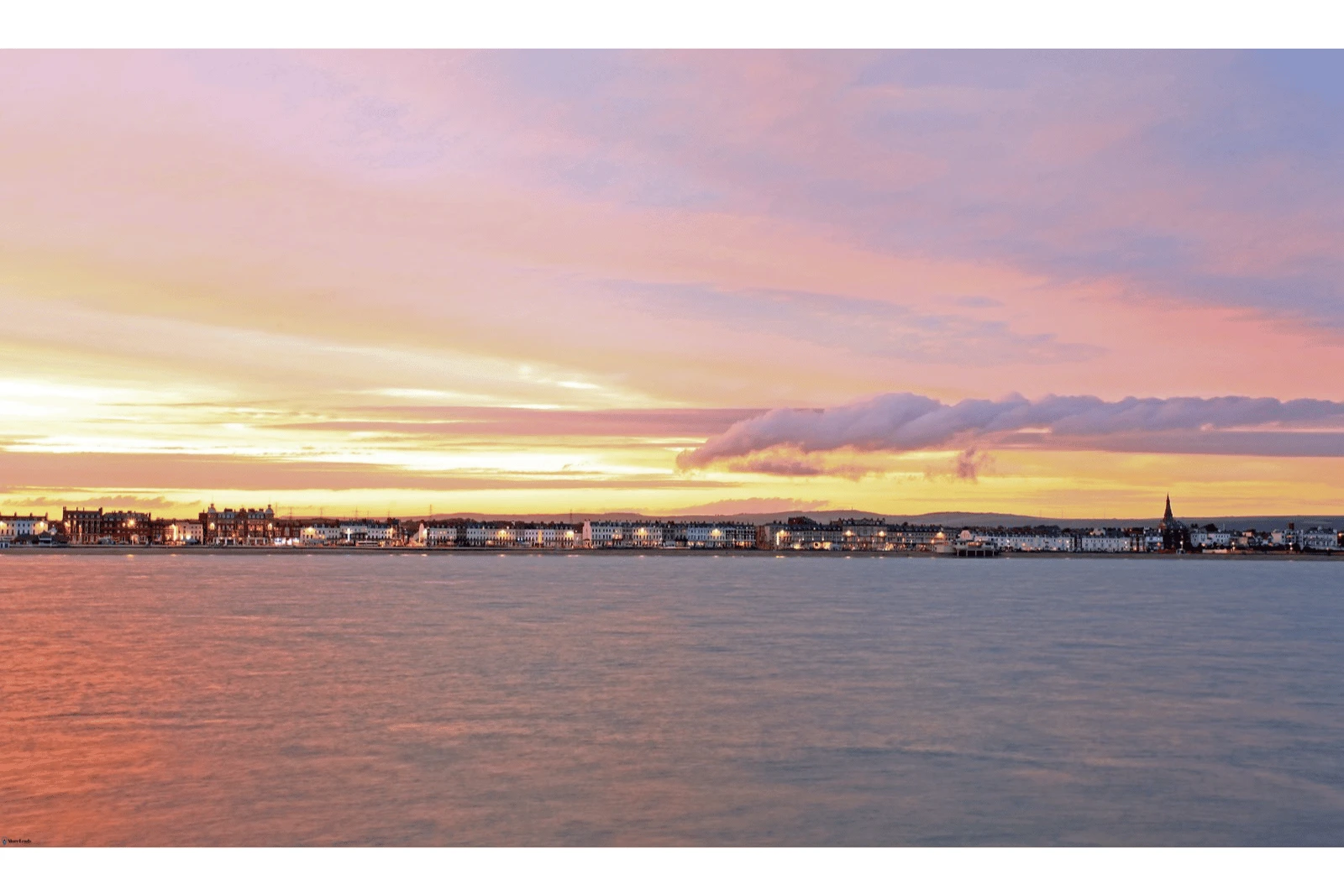 Sunset over Weymouth Seafront from out to sea. Weymouth Seafront is an competitive area for businesses.